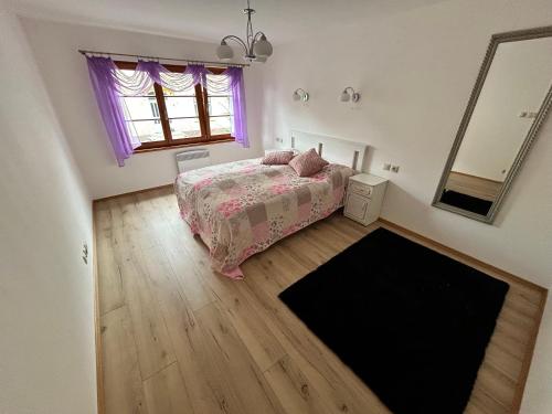 a bedroom with a bed and a mirror at Nicole in Hartau