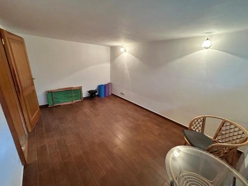 an empty room with a wooden floor and two lights at Nicole in Hartau