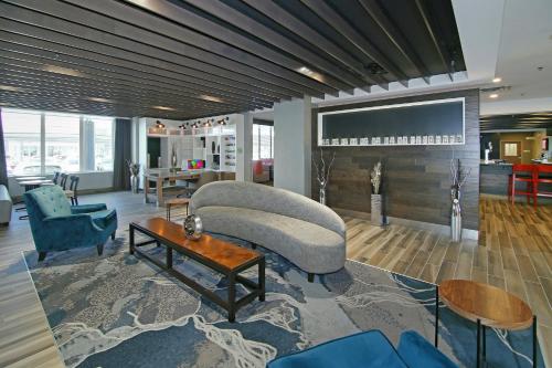 a living room with a couch and a table at Holiday Inn Hotel & Suites - Calgary Airport North by IHG in Calgary