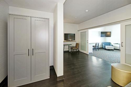 a room with a white closet and a living room at Holiday Inn Hotel & Suites - Calgary Airport North by IHG in Calgary
