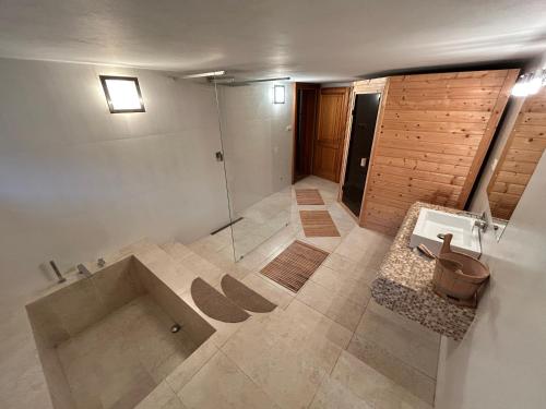a bathroom with a shower and a tub and a sink at Nicole in Hartau