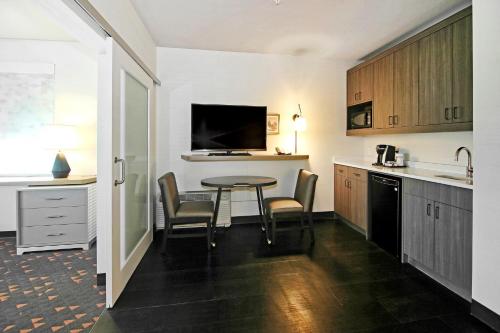 a kitchen with a table and chairs in a room at Holiday Inn Hotel & Suites - Calgary Airport North by IHG in Calgary