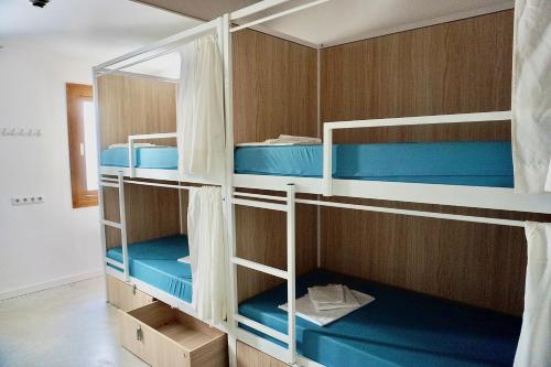 a bunk bed with blue bunk beds in a room at Urban Hostel Palma - Albergue Juvenil - Youth Hostel in Palma de Mallorca