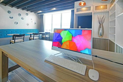 a computer monitor sitting on top of a wooden table at Holiday Inn Hotel & Suites - Calgary Airport North by IHG in Calgary