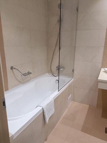 un baño con bañera y ducha en Miha DeLuxe Rooms, en Bucarest