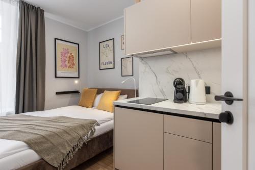 a small room with a bed and a kitchen at P6-A Riga Old Town Apartments in Rīga