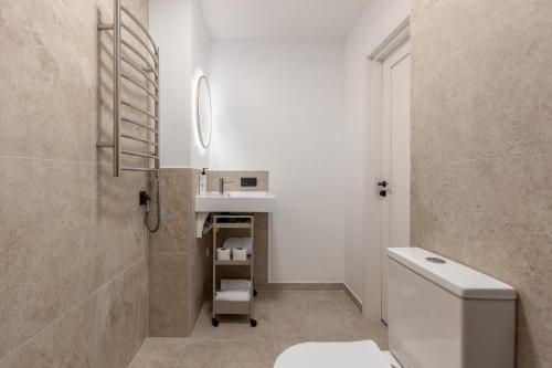 a bathroom with a white toilet and a sink at P6-A Riga Old Town Apartments in Rīga