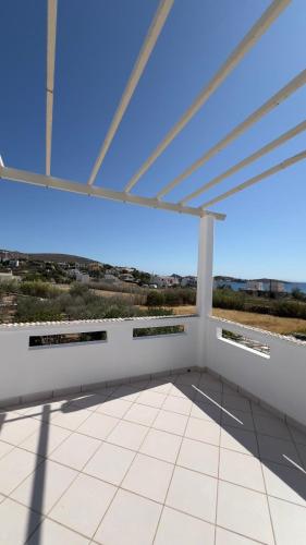 a view from a roof top patio with a large window at Syros Rooms & Apartments in Posidhonía