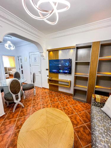 a living room with a table and a tv at Appart-hôtel Costa Azul - Solarium in Oued Laou