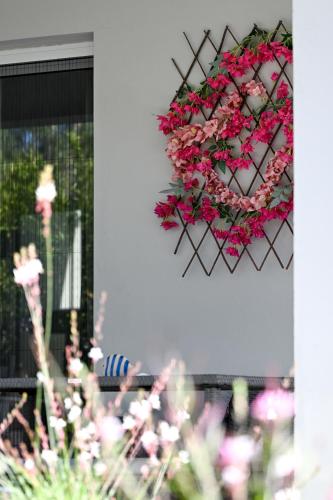 a wreath of pink flowers hanging on a wall at Anchor Villa in Troulos