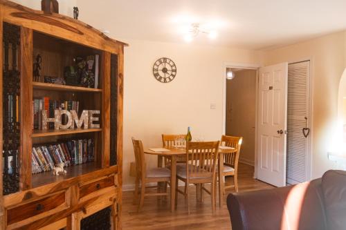 a dining room with a table and a book shelf at Three Bedrooms Flat in Central Edinburgh Old Town in Edinburgh