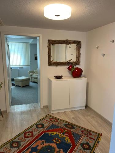 a living room with a mirror and a rug at Kerstins Lieblingsdomizil in Oelsnitz