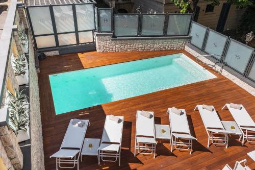 an overhead view of a swimming pool with lounge chairs and a swimming pool at LHP River Club in Florence