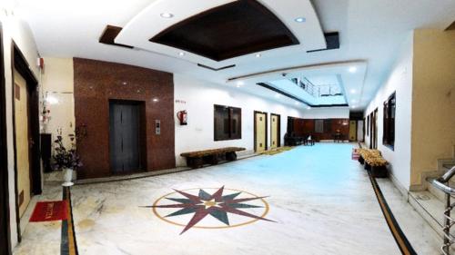 a large hallway with a large room with a large ceiling at Hotel HK Continental in Amritsar