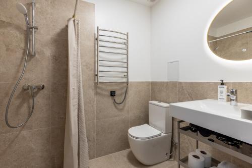 a bathroom with a shower and a toilet and a sink at P6-A Riga Old Town Apartments in Rīga