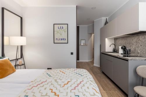 a bedroom with a king sized bed and a kitchen at P6-A Riga Old Town Apartments in Rīga