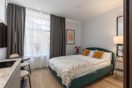 a hotel room with a bed and a window at P6-A Riga Old Town Apartments in Rīga