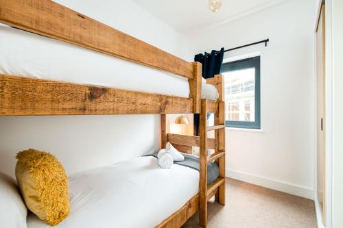 two bunk beds in a room with a window at The Cotswold Light House ML63 Lower Mill Estate in Somerford Keynes