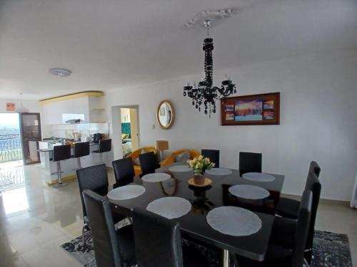 a dining room with a black table and chairs at Orca Estate Guesthouse Self-catering Accommodation in Durban