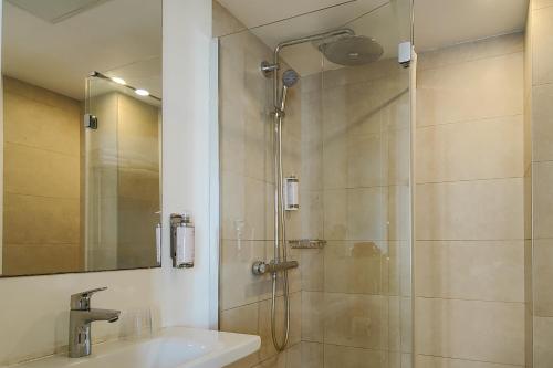 a bathroom with a shower and a sink at Hôtel Du Centre, un hôtel AMMI in Nice