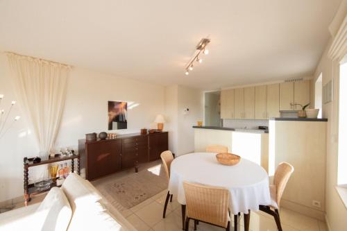 a kitchen and dining room with a table and chairs at Promenade J 0402 in Koksijde