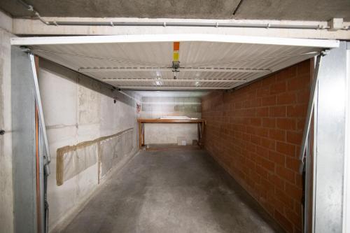 an empty hallway in a building with a brick wall at Promenade J 0402 in Koksijde