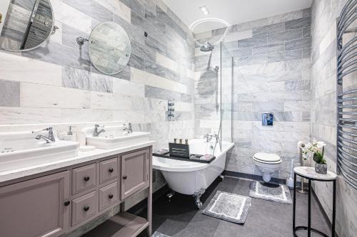 a bathroom with a sink and a toilet at Spacious High End 3-Bedroom Apartment Sleeps 6 in Midland