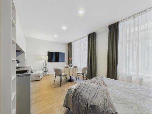 a bedroom with a bed and a living room with a table at P6-A Riga Old Town Apartments in Rīga