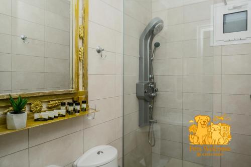 a bathroom with a shower with a monkey sticker on the wall at EVLOGIA HOTEL SEAFRONT and ANEX by Greek Pride in Fourka
