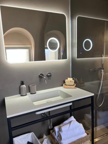 a bathroom with a sink and a mirror at Nausicaa Guesthouse in Marsala