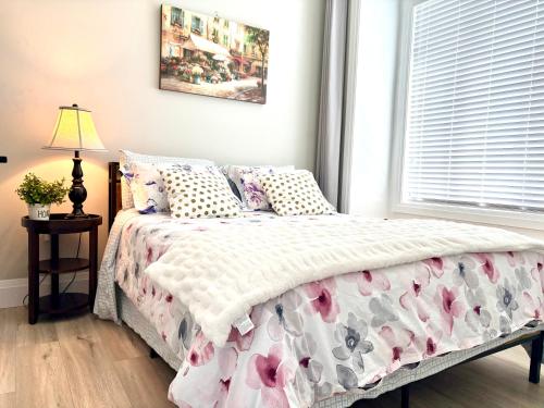 a bedroom with a bed with a pink and white comforter at Home sweet home in Richmond