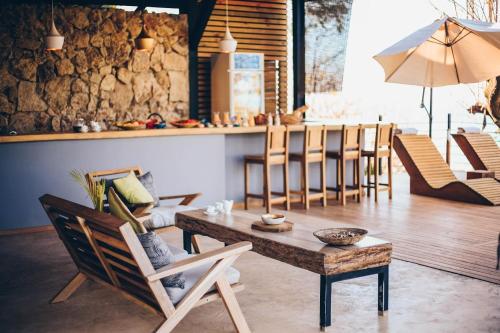 a living room with a table and chairs at Vista del Alma Boutique - Adult Only in Santa Teresa Beach