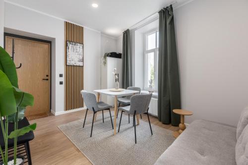 a living room with a table and chairs at P6-A Riga Old Town Apartments in Rīga