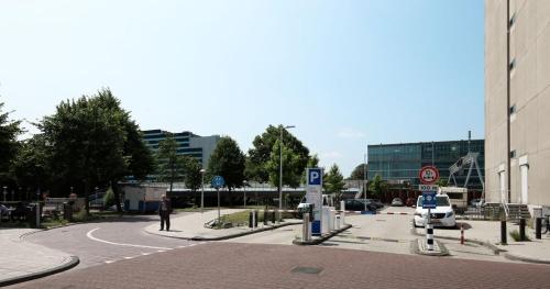 a street with a car parked in a parking lot at Cityden BoLo District in Amsterdam