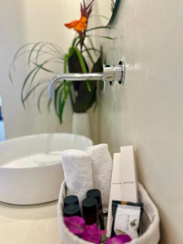 a bathroom with a sink and a toilet paper dispenser at Rea Boutique Hotel in Himare