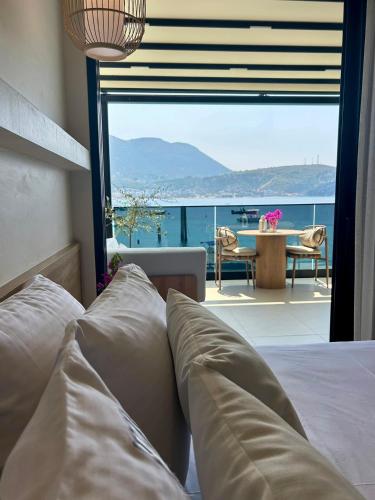 a bedroom with a bed and a view of the ocean at Rea Boutique Hotel in Himare