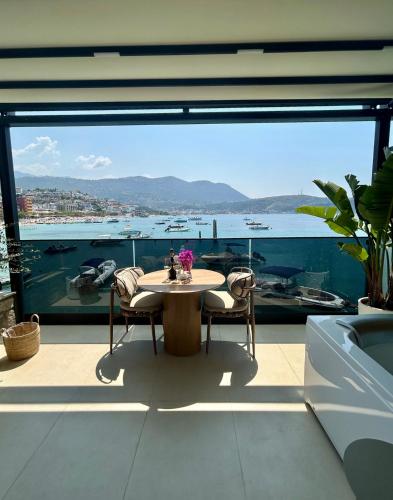 a room with a table and a view of the water at Rea Boutique Hotel in Himare