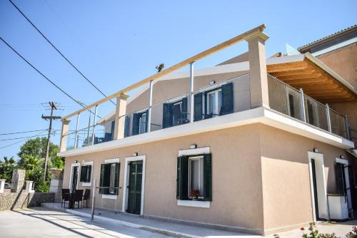 a building with a balcony on top of it at Anestis Apartments in Kontokali