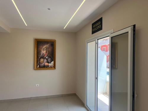 a room with a painting of a soldier on the wall at Kanaj Rooms and Apartments in Vlorë