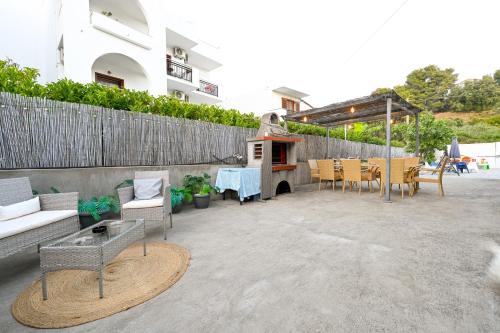 a patio with a table and chairs and a grill at Anchor Villa in Troulos