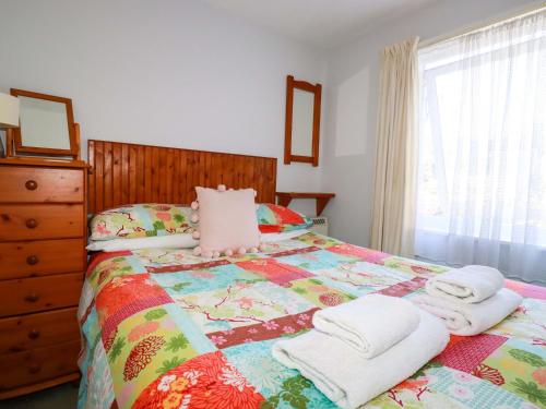 a bedroom with a bed with towels on it at Chyancrowse in Penzance