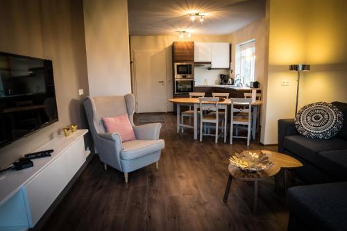a living room with a couch and a dining room at Breidamyri Farm Apartments in Laugar