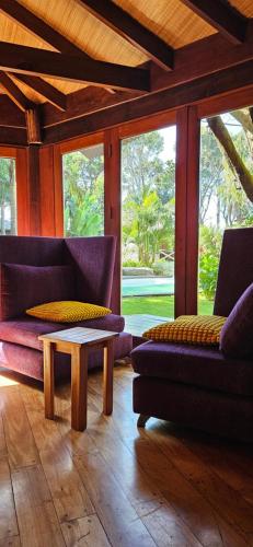 a living room with purple couches and a coffee table at Complejo Aramis Chapadmalal in Chapadmalal