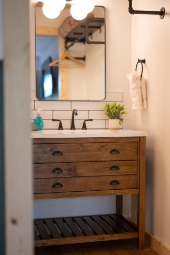 a bathroom with a sink and a mirror at The Woodsman Lodge in Eureka Springs