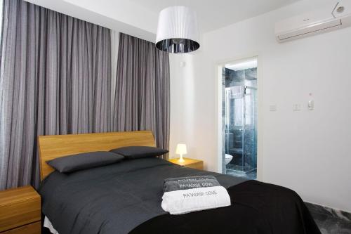 a bedroom with a large bed with a black blanket at Luxury Cyprus Villa Aqua Villa Private Pool Sea View 2 Bdr Paphos in Paphos