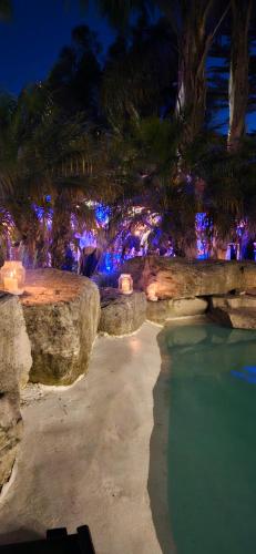 a backyard with a pool of water with lights at Complejo Aramis Chapadmalal in Chapadmalal