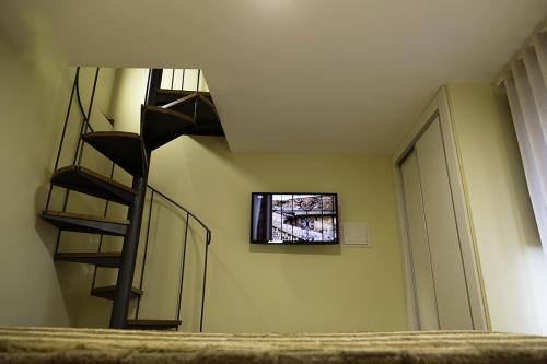a room with a spiral staircase and a window at Casa Vale da Fonte in Geres