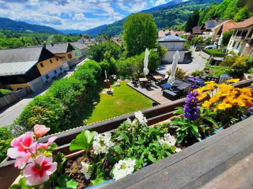 a view of a garden with flowers on a balcony at Pension Sonnenheim in Gmünd in Kärnten