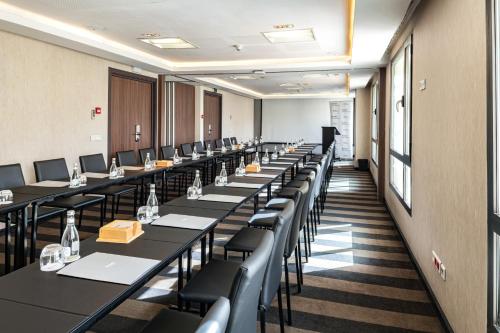 a row of tables and chairs in a room at Barceló Fès Medina in Fez