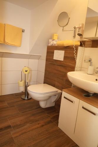 a bathroom with a toilet and a sink at Hotel Gasthof zur Linde in Mariahof